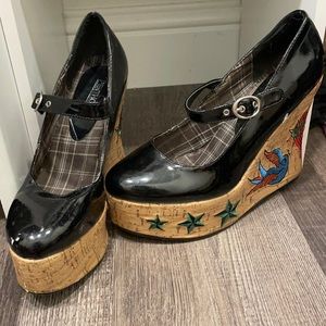 Black patent embroidered cork wedges.